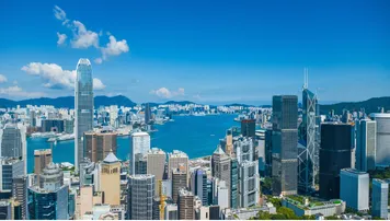 Aerial view of Hong Kong business skyscrapers, Victoria Harbour, Kowloon and Hong Kong Island. 